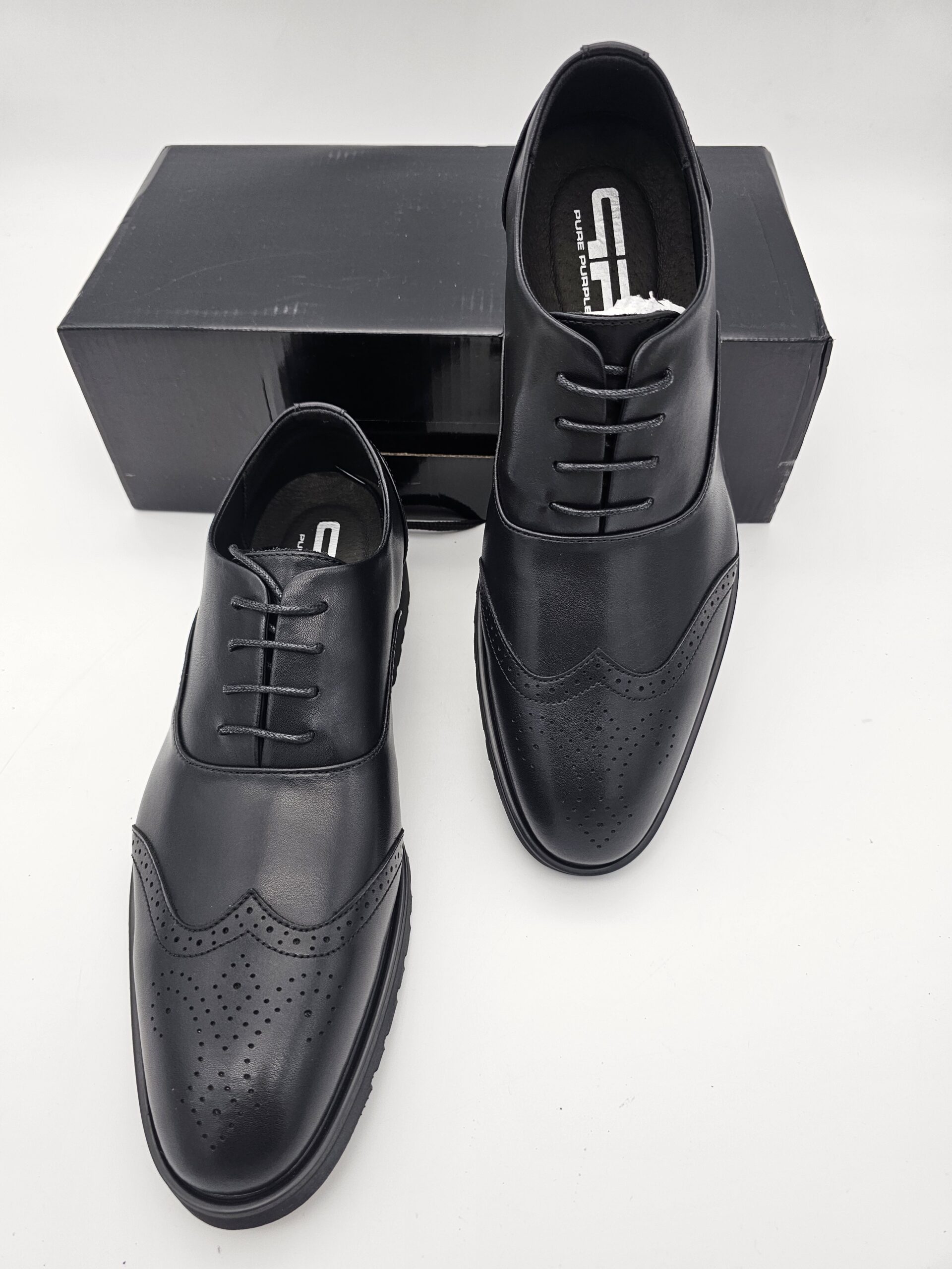 Black leather Oxford shoes for men by Pure Purple featuring genuine leather uppers, padded insoles and durable rubber soles.